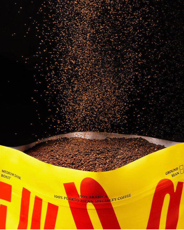Image of front of bag with ground coffee poofing out of the top