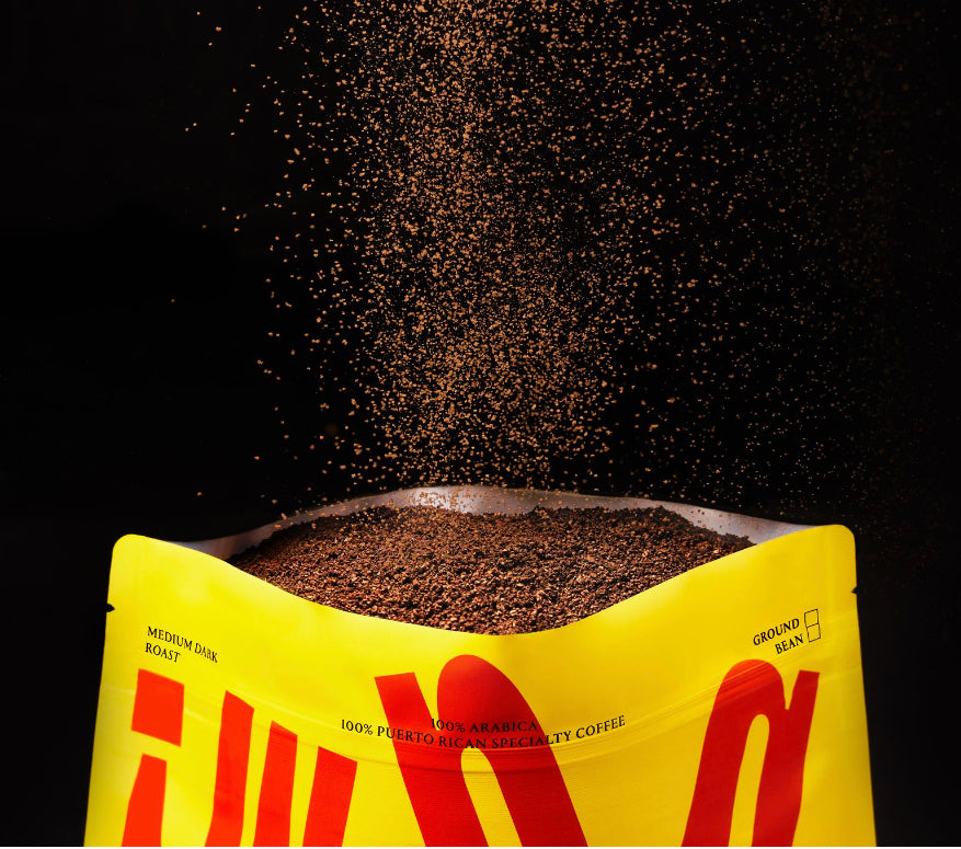 Image of front of bag with ground coffee poofing out of the top